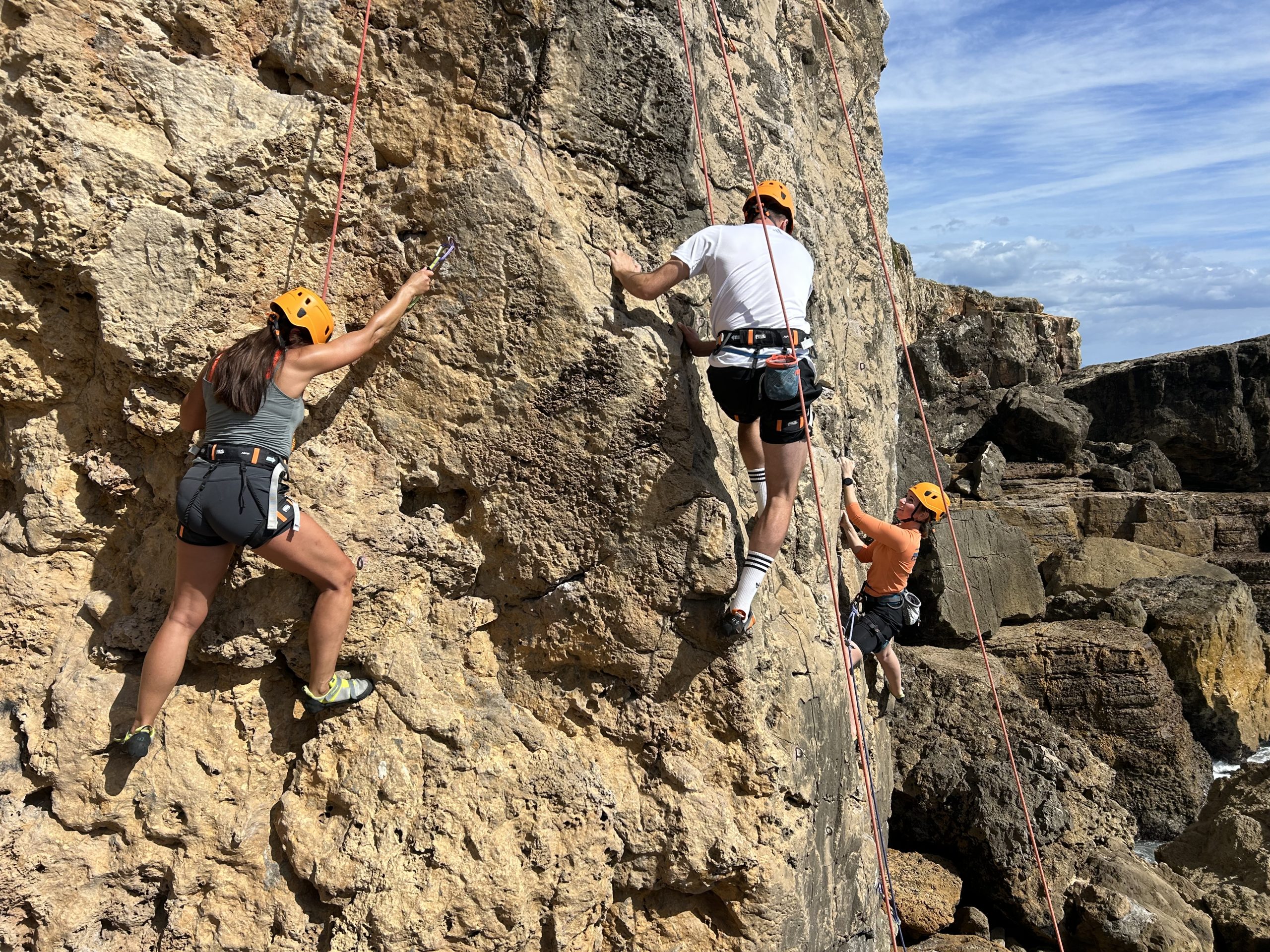 Group_of_people_rock_climbing_in_Cascais_Portugal_enjoying_the_scenic_cliffs_and_adventurous_experience