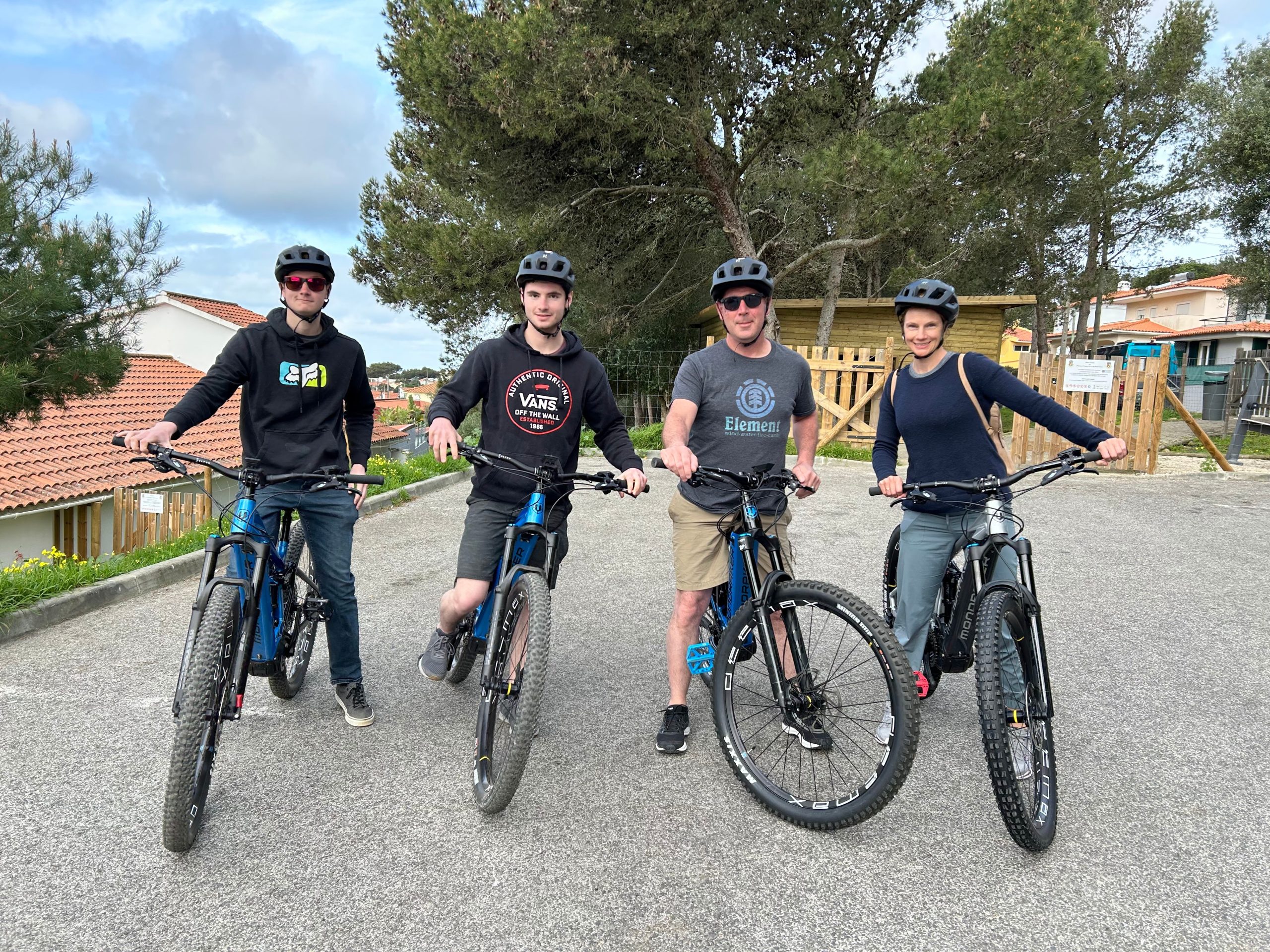 Group of e-bikers posing together on a forest trail