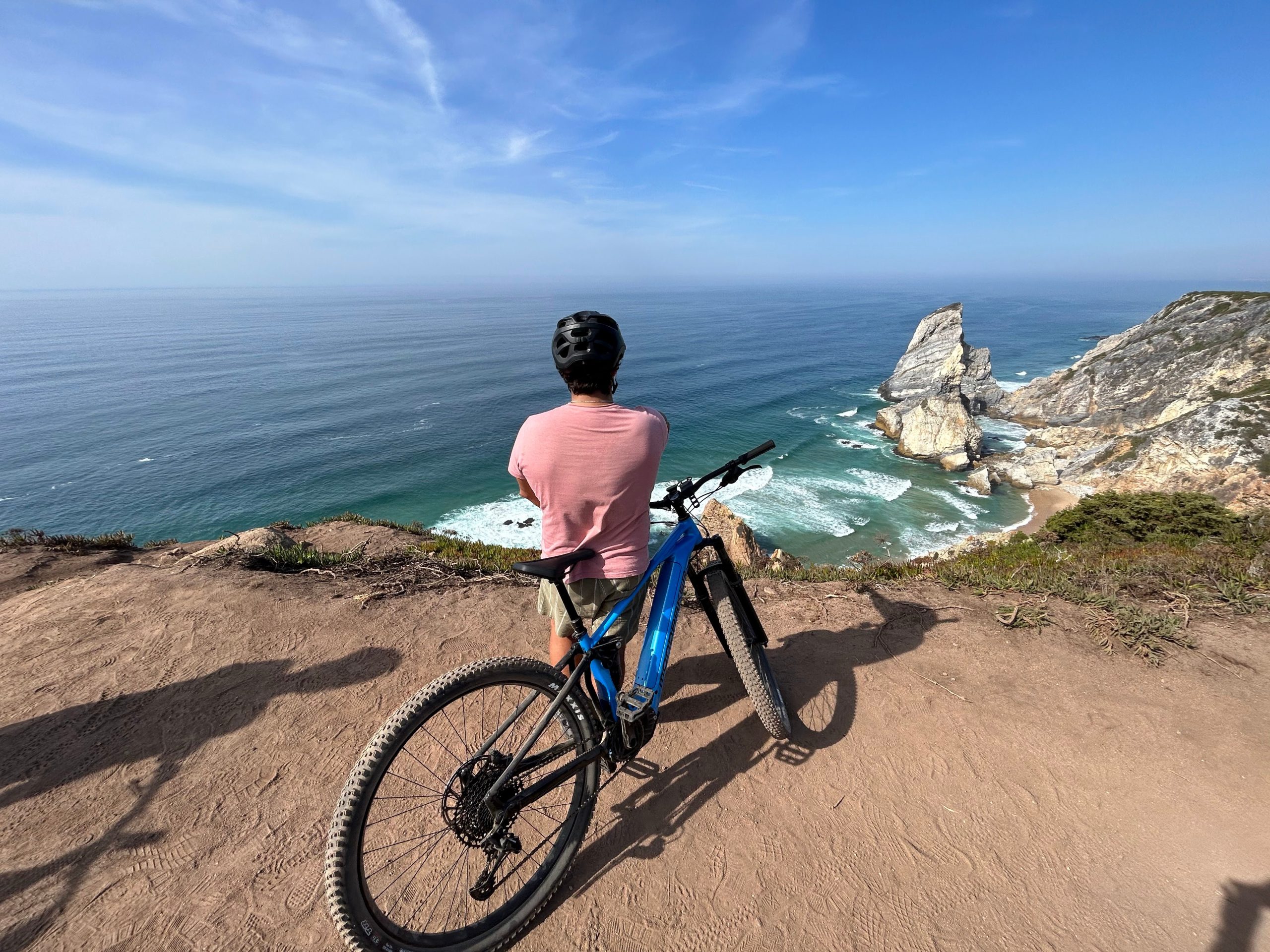 E-biker riding a scenic cliffside path near Cascais
