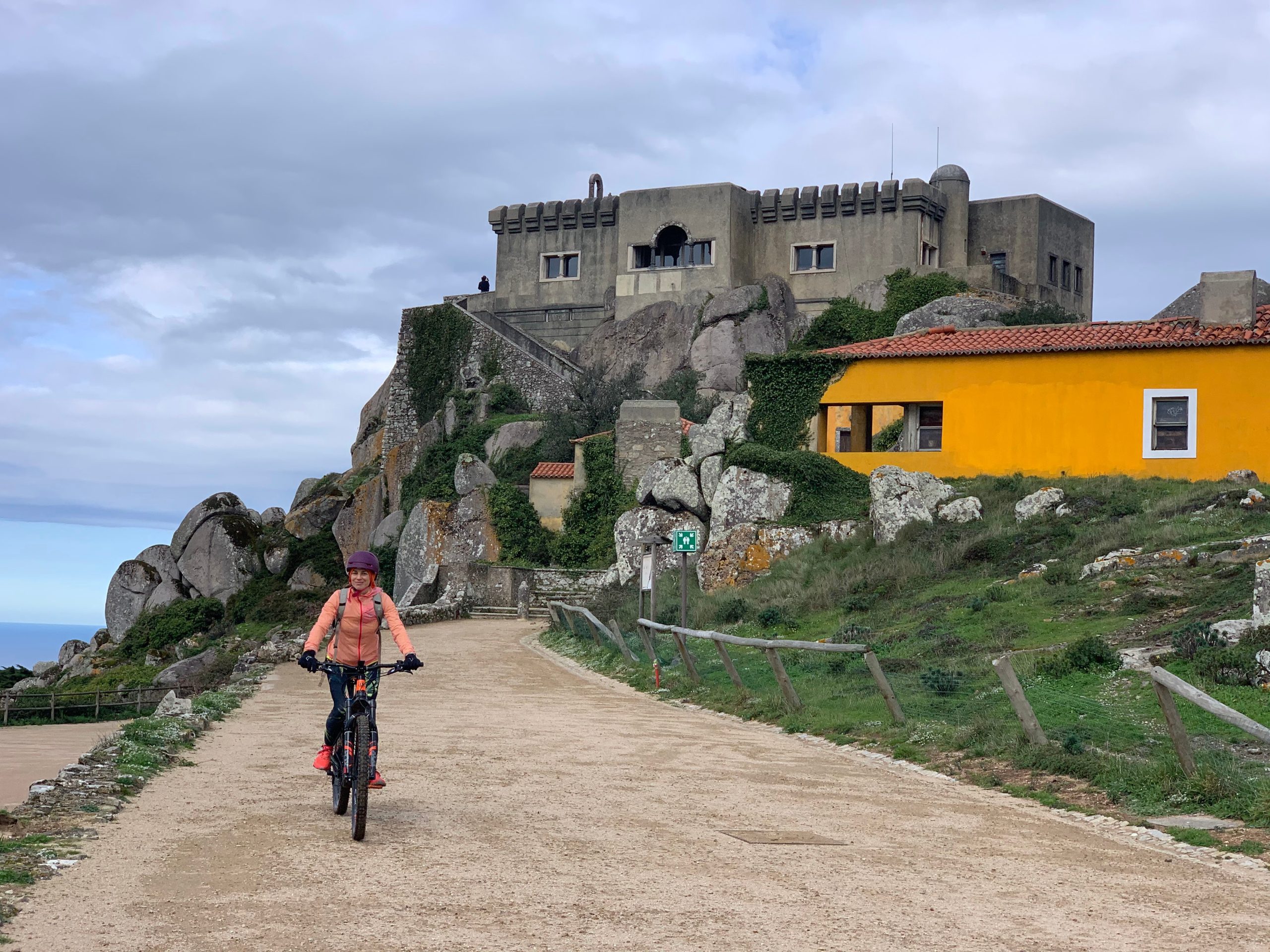 E-biker riding past a historic stone fort near Sintra