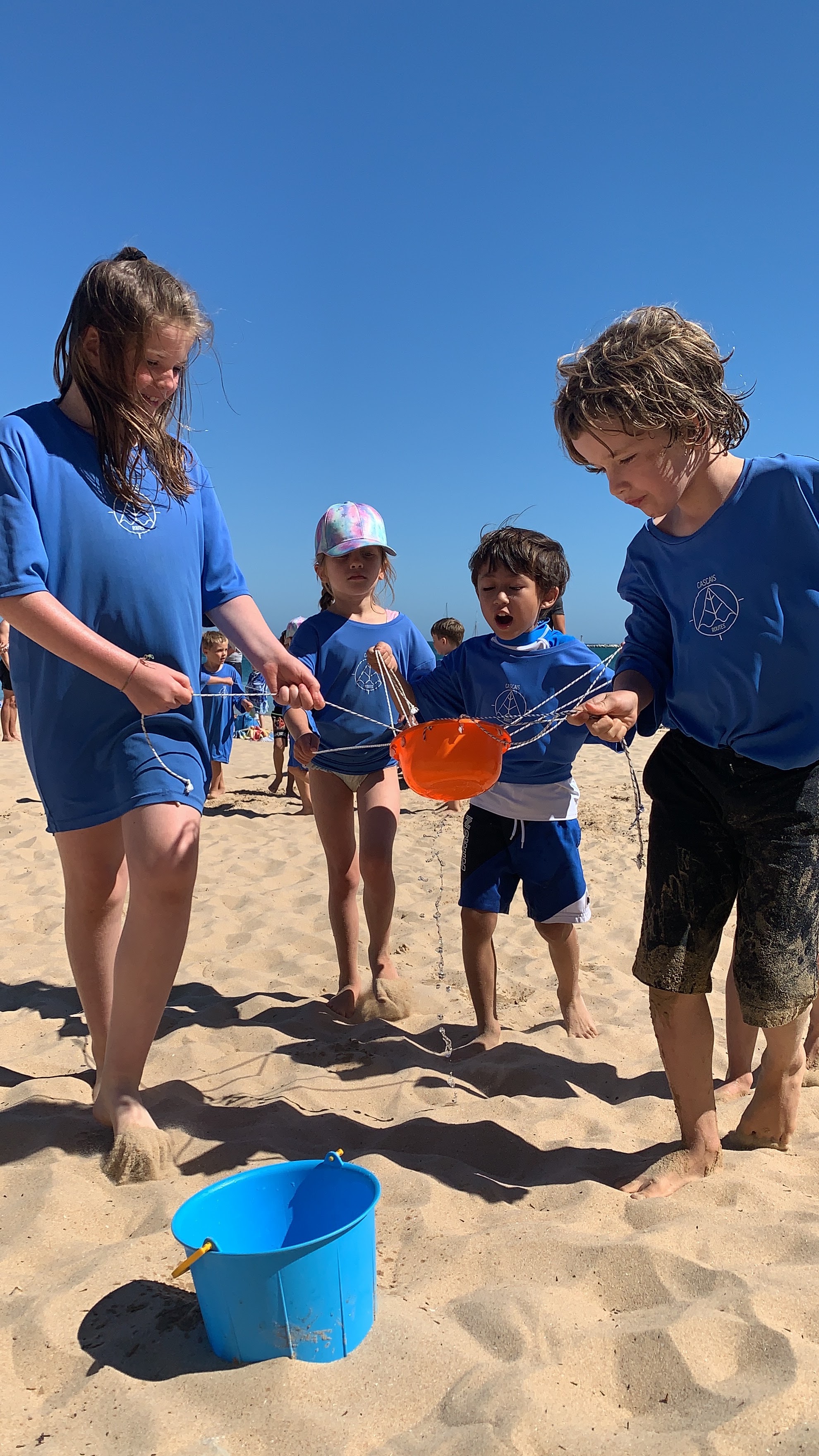 Kids playing beach team games at a Cascais Routes birthday party
