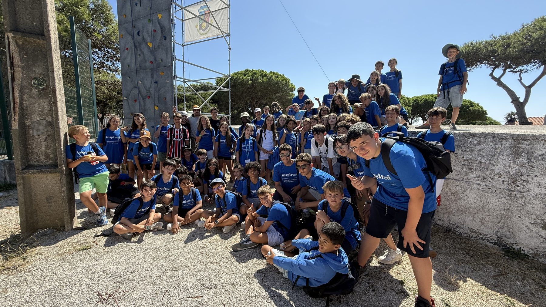 International school group in front of the climbing tower at a Cascais Routes adventure retreat